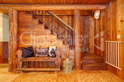 Rustic log cabin stairace and bench details.