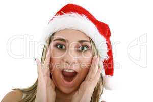 woman in santa hat surprised for Christmas.