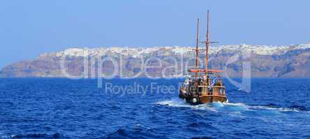 Tourists boat going to Oia, Santorini, Greece
