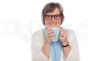 Smiling lady drinking hot coffee