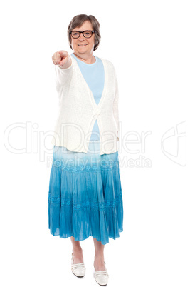 Fashionable woman pointing at you