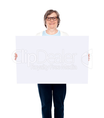 Aged woman displaying blank poster