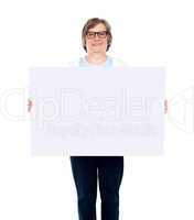Aged woman displaying blank poster