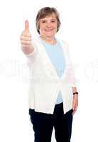 Smiling old lady showing thumbs up gesture