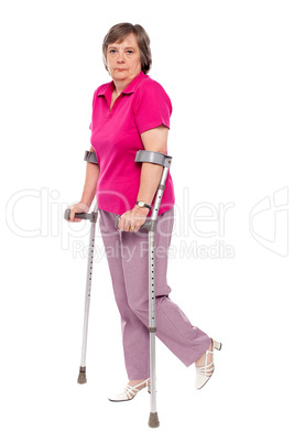 Unhappy handicapped woman with crutches