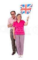 Old couple waving UK flag. Supporting nation