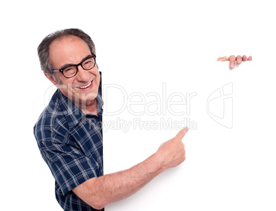 Man pointing at white blank poster