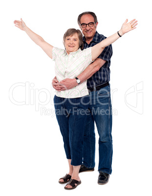 Man hugging his wife from behind