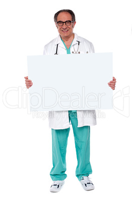 Confident doctor showing blank whiteboard
