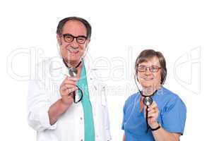 Smiling aged male and female doctors