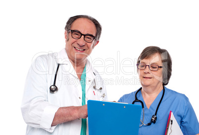 Senior doctors reading medical report