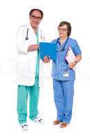 Doctor and nurse analyzing report together