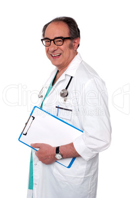 Senior male doctor holding blank clipboard