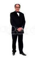 Attractive senior man posing in tuxedo