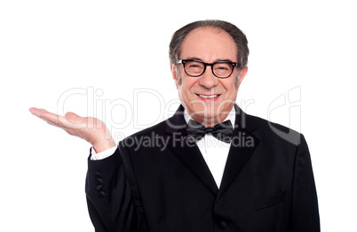 Man in party wear presenting copy space