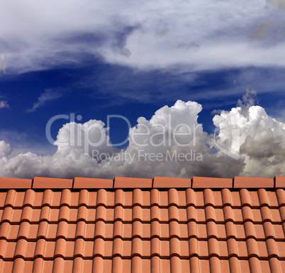 Roof tiles and blue sky with clouds