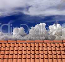 Roof tiles and blue sky with clouds