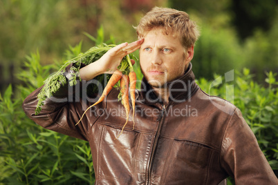 Young man holding carrots
