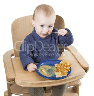 young child eating in high chair