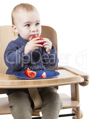 young child eating in high chair