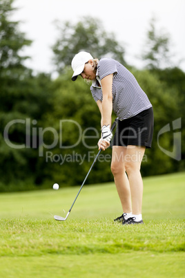 Frau spielt Golf auf einem Golfplatz