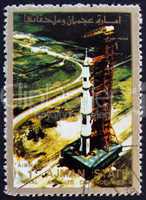 Postage stamp Ajman 1973 Roll out of Saturn 5 on launch pad