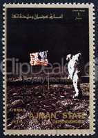 Postage stamp Ajman 1973 Aldrin Salutes U.S. Flag on the Lunar S
