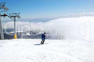 Skier rides on a slope in Strbske Pleso ski resort, High Tatras,