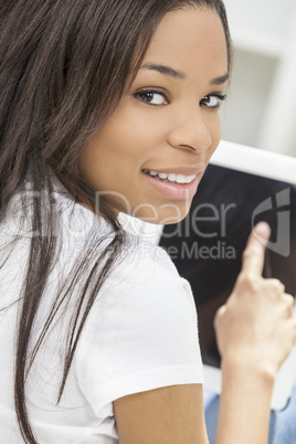 African American Woman Using Tablet Computer At Home