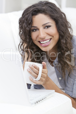 Woman Smiling Drinking Tea or Coffee Using Laptop Computer