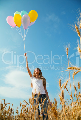 teen girl at a wheat field with balloons