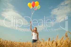 teen girl at a wheat field with balloons
