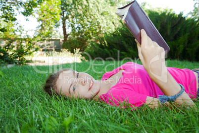 teen girl reading the bible outdoors