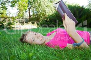 teen girl reading the bible outdoors