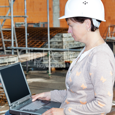 Civil engineer with a laptop on site