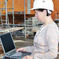 Civil engineer with a laptop on site