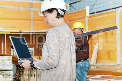 Civil engineer with a laptop on site