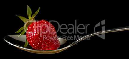 red,fresh strawberry on spoon
