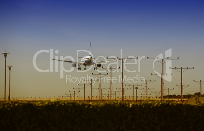 Airplane approaching for Touchdown at sunset