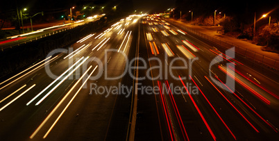 Highway Traffic at night with carlights passing by