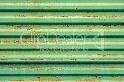 Rusty metal surface painted in green