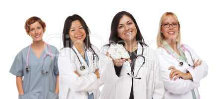 Hispanic Female Doctor or Nurse with Baby Shoes and Support Staf