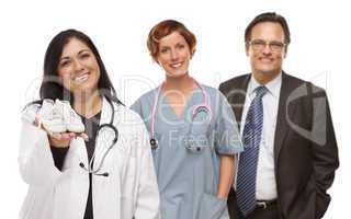 Hispanic Female Doctor or Nurse with Baby Shoes and Support Staf