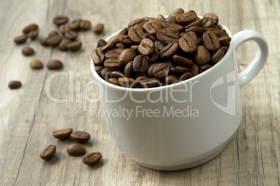 a pile of coffee beans on the wooden background