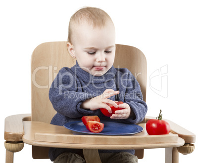 young child eating in high chair