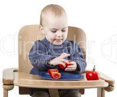 young child eating in high chair