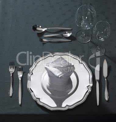 exclusive place setting on dark tablecloth