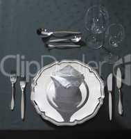 exclusive place setting on dark tablecloth