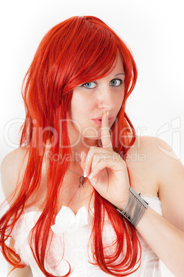 Woman with red hair keeps fingers to his mouth