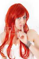 Woman with red hair keeps fingers to his mouth